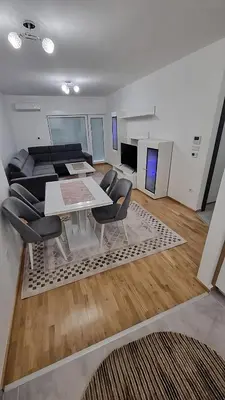 a living room with a table and chairs and a couch at Valley of Pyramids Residence in Visoko