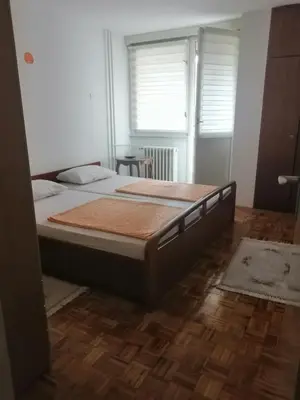 a bedroom with a large bed in a room at HomeB&E in Tuzla