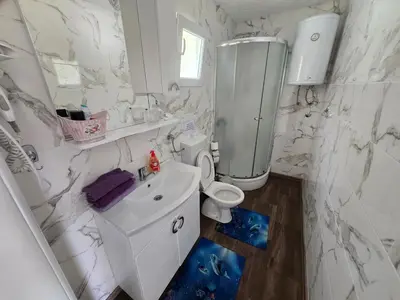 a white bathroom with a toilet and a sink at Vikendica SUNCE in Banja Luka