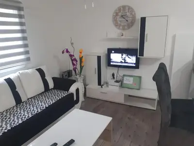 a living room with a couch and a tv at Vikendica SUNCE in Banja Luka
