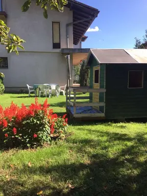a house with a table and chairs in a yard at Studio apartman NINA in Bihać
