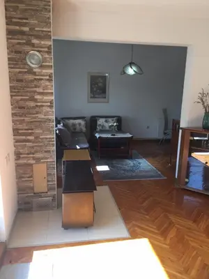 a living room with a couch and a table at Studio apartman NINA in Bihać