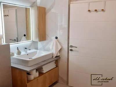 a bathroom with a sink and a shower at Old School Apartments in Banja Luka