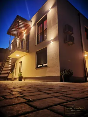 a building with stairs and windows at night at Old School Apartments in Banja Luka