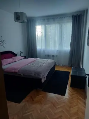 a bedroom with a bed and a large window at Stan na dan Novi Grad in Bosanski Novi