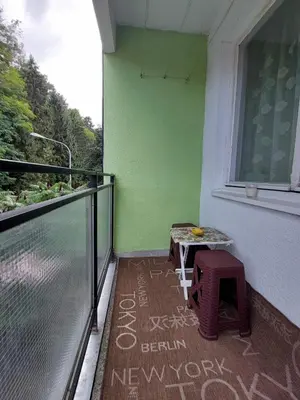 a balcony with a table and a window at Stan na dan Novi Grad in Bosanski Novi