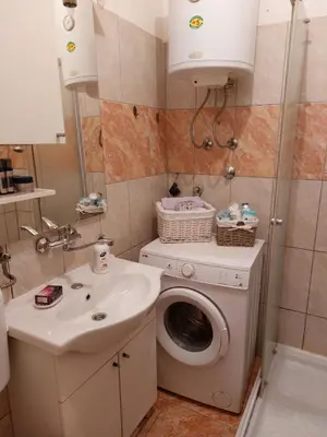 a bathroom with a washing machine and a sink at Stan na dan Novi Grad in Bosanski Novi