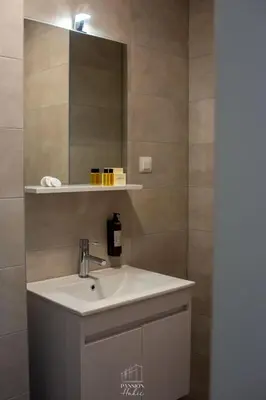 a bathroom with a sink and a mirror at Pansion Hukić B&B in Tuzla