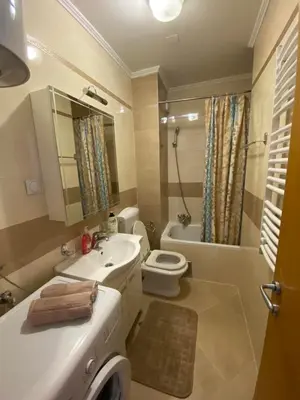 a bathroom with a sink and a toilet and a tub at Apartmani Casa in Banja Luka