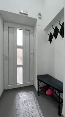 a white room with a table and a window at Apartmani Aurora in Tuzla