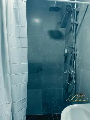 a bathroom with a shower with a toilet and a sink at Motel Platani Kotor Varoš in Kotorište
