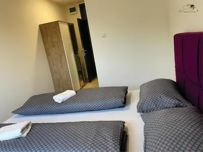 two beds in a room with a mirror at Motel Platani Kotor Varoš in Kotorište