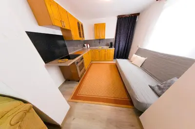 a small kitchen with a couch in a room at Apartman Bucko in Bihać