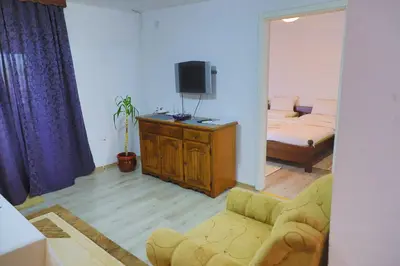 a living room with a couch and a tv at Apartman Bucko in Bihać