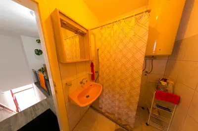 a bathroom with a toilet and a sink in it at Apartman Bucko in Bihać