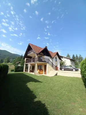 a house with a green lawn in front of it at Apartman Milekic in Mrkonjić Grad