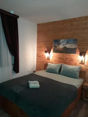 a bedroom with a large bed with two pillows at Apartman Milekic in Mrkonjić Grad