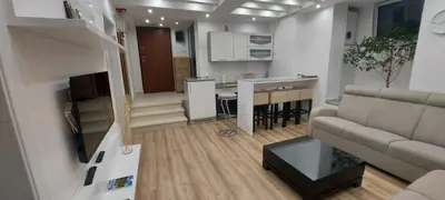 a small living room with a couch and a kitchen at Apartman Dona in Banja Luka