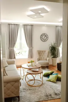 a living room with a couch and a table at Fontana apartmani 1 FREE parking in Tuzla