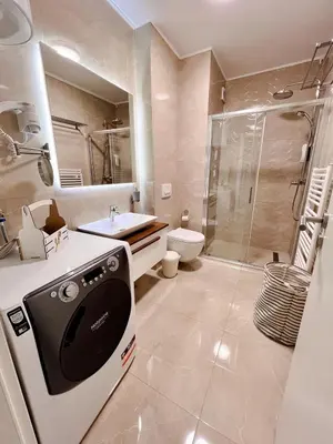 a bathroom with a shower and a toilet and a sink at Fontana apartmani 1 FREE parking in Tuzla