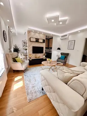 a living room with a couch and a table at Fontana apartmani 1 FREE parking in Tuzla