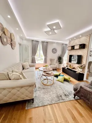 a living room with a couch and a table at Fontana apartmani 1 FREE parking in Tuzla