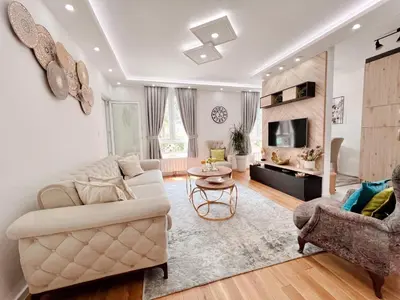a living room with a couch and a table at Fontana apartmani 1 FREE parking in Tuzla