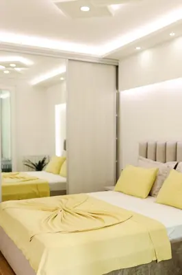 a bedroom with two beds and a mirror at Fontana apartmani 1 FREE parking in Tuzla