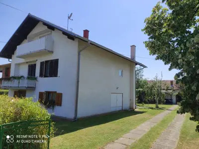 an old white house with a grass yard at Home of nature - kuća prirode in Odžak