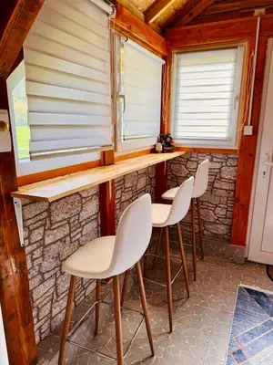 a room with four chairs and a counter with windows at Apartman Visoko-Oaza mira in Visoko