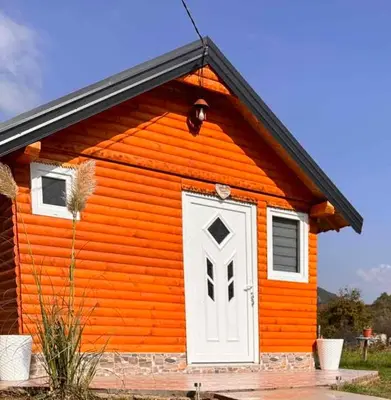 a small orange house with a white door at Apartman Visoko-Oaza mira in Visoko