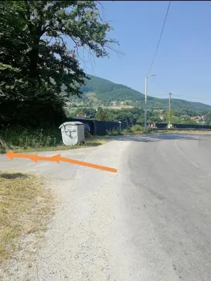 an empty road with an orange arrow on it at Apartman Visoko-Oaza mira in Visoko