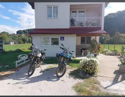 two motorcycles parked in front of a house at Apartman Visoko-Oaza mira in Visoko
