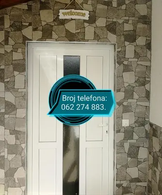 a sign on a door with a sign on it at Apartman Visoko-Oaza mira in Visoko