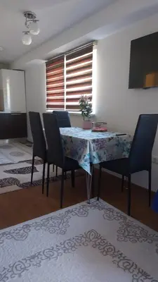 a dining room with a table with chairs and a tableablish at Indy in Travnik