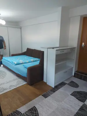 a small room with a bed and a dresser at Indy in Travnik