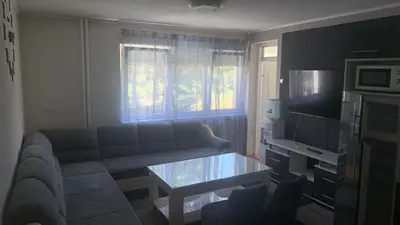 a living room with a couch and a table at Stan na dan Banovići in Banovići