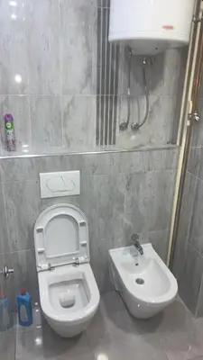 a small bathroom with a toilet and a sink at Stan na dan Banovići in Banovići