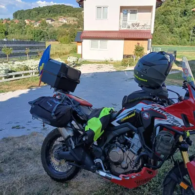 a red motorcycle parked in front of a house at Oaza mira Visoko in Visoko