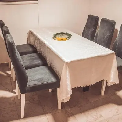 a table with chairs and a white table cloth on it at 