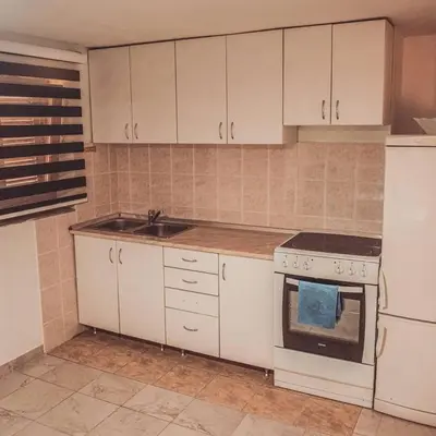 a kitchen with white cabinets and a sink and a stove at 