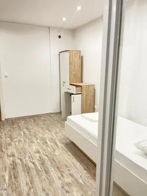 a room with two beds and a refrigerator at Una Bihac 4 in Bihać