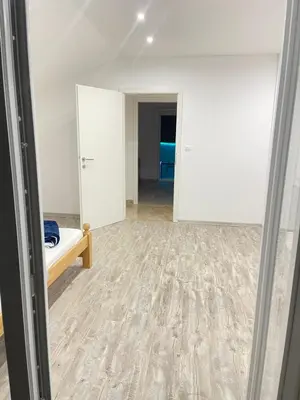 an empty room with a bed and a hallway at Una Bihac 4 in Bihać