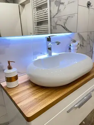 a white sink on a wooden counter in a bathroom at Una Bihac 4 in Bihać