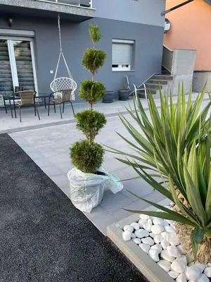a patio with two potted plants and a swing at Una Bihac 4 in Bihać