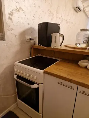 a kitchen with a stove top oven next to a counter at Vikendica Konstantin Slatina-Banja Luka in Laktaši