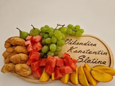 a plate of food with grapes and fruit on it at Vikendica Konstantin Slatina-Banja Luka in Laktaši