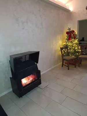 a living room with a fireplace and a christmas tree at Vikendica Konstantin Slatina-Banja Luka in Laktaši
