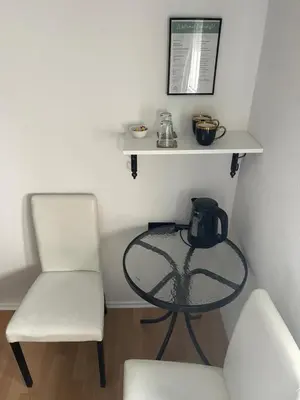 a table and a chair and a tea kettle on a table at Sobe kod bolnice Paprikovac in Banja Luka