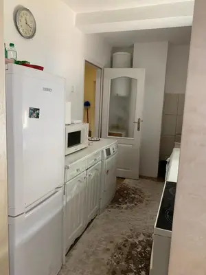 a kitchen with a white refrigerator and a microwave at Anja Apartman in Bosanski Šamac